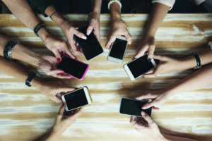 Top view hands circle using phone in cafe.